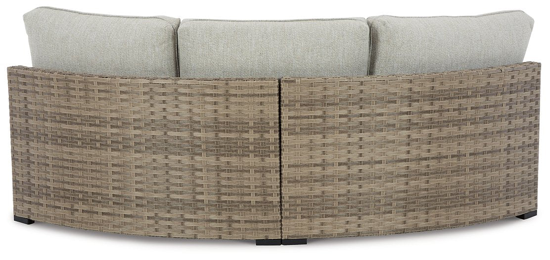 Calworth Outdoor Curved Loveseat with Cushion - Yulissa Home Furnishings (NJ)