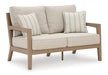 Hallow Creek Outdoor Loveseat with Cushion - Yulissa Home Furnishings (NJ)